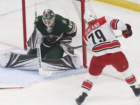 Minnesota Wild goalie Devan Dubnyk makes a glove save on a shot by Carolina Hurricanes' Micheal Ferland during the first period of an NHL hockey game Saturday, Oct. 13, 2018, in St. Paul, Minn.