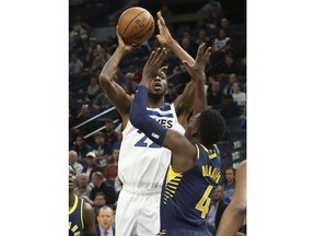 Minnesota Timberwolves' Andrew Wiggins, left, looks to shoot as Indiana Pacers' Victor Oladipo defends in the first half of an NBA basketball game Monday, Oct. 22, 2018, in Minneapolis.