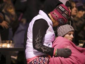 People attend a gathering during a moment of silence for Jayme Closs at the Barron High School Football Stadium, Monday, Oct. 22, 2018. Authorities  revealed they're looking for two vehicles in connection with the disappearance of the Wisconsin girl whose parents were gunned down last week, calling on hundreds of volunteers to resume a ground search. State, local and federal investigators have been searching for Closs since early Oct. 15, when deputies discovered someone had broken into the family's rural Barron home and shot her parents to death.