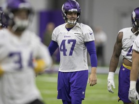 In this Sept. 20, 2018 photo, Minnesota Vikings long snapper Kevin McDermott, right,  watches during NFL football practice in Eagan, Minn.