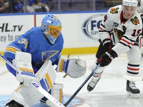St. Louis Blues goalie Jake Allen (34) blocks a shot by Chicago Blackhawks' Jonathan Toews (19) during the first period of an NHL hockey game, Saturday, Oct. 6, 2018, in St. Louis.