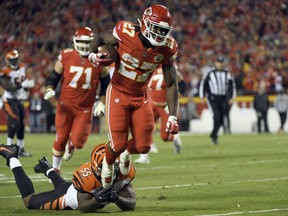 Kansas City Chiefs running back Kareem Hunt (27) is tackled by Cincinnati Bengals linebacker Vontaze Burfict (55) during the first half of an NFL football game in Kansas City, Mo., Sunday, Oct. 21, 2018.