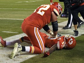 Kansas City Chiefs offensive lineman Eric Fisher (72) pretends to do CPR on wide receiver Tyreek Hill (10) after Hill scores a touchdown during the second half of an NFL football game against the Cincinnati Bengals in Kansas City, Mo., Sunday, Oct. 21, 2018. The Chiefs won, 45-10.