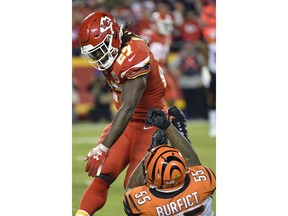 Kansas City Chiefs running back Kareem Hunt (27) pushes off a tackle attempt by Cincinnati Bengals linebacker Vontaze Burfict (55) during the second half of an NFL football game in Kansas City, Mo., Sunday, Oct. 21, 2018. The Chiefs won, 45-10.