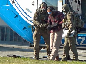 Police officers escort Moroccan terror accomplice Mounir el Motassadeq after he was brought with a helicopter from the Fuhlsbuettel prison to the airport in Hamburg, northwestern Germany, on October 15, 2018.