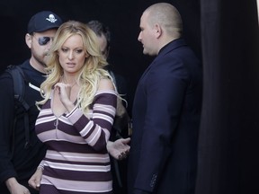 Adult film actress Stormy Daniels, center, arrives for the opening of the adult entertainment fair 'Venus' in Berlin, Germany, Thursday, Oct. 11, 2018.