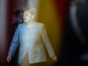 German Chancellor Angela Merkel walks through the foyer of the chancellery to welcome Chile's President Sebastian Pinera for a meeting in Berlin, Wednesday, Oct. 10, 2018.