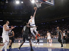 New York Knicks' Mario Hezonja (8) drives past Brooklyn Nets' Ed Davis (17) during the first half of an NBA basketball game Monday, Oct. 29, 2018, in New York.