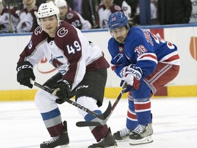Colorado Avalanche defenseman Samuel Girard (49) and New York Rangers right wing Mats Zuccarello (36) chase a loose puck during the first period of an NHL hockey game, Tuesday, Oct. 16, 2018, at Madison Square Garden in New York.