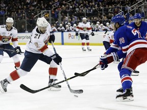 Florida Panthers' Vincent Trocheck (21) shoots the puck past New York Rangers' Brady Skjei (76) during the first period an NHL hockey game Tuesday, Oct. 23, 2018, in New York.