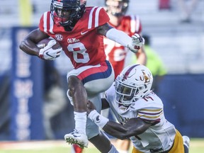 Mississippi wide receiver Elijah Moore (8) is tackled by Louisiana Monroe linebacker David Griffith (14)  during an NCAA college football game at Vaught-Hemingway Stadium in Oxford, Miss. on Saturday, Oct. 6, 2018.