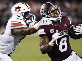 Mississippi State running back Kylin Hill (8) breaks away from a attempted tackle by Auburn linebacker Darrell Williams (49) as he runs for a first down during the first half of their NCAA college football game in Starkville, Miss., Saturday, Oct. 6 2018.