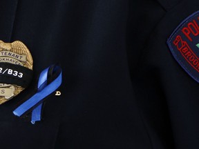 A Brookhaven, Miss., police lieutenant's badge is wrapped with a black ribbon and the call numbers of officer James White and Corporal Zach Moak, at the funeral of White, Wednesday, Oct. 3, 2018 in Brookhaven. The two were killed early Saturday, Sept., responding to a call.