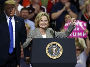 Sen. Cindy Hyde-Smith, R-Miss., urges the audience to cheer for Republican President Donald Trump after he introduced her at a rally Tuesday, Oct. 2, 2018, in Southaven, Miss. Hyde-Smith is running for the final two years of the term of former Republican Sen. Thad Cochran, who retired last year.