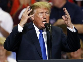 President Donald Trump gestures as he speaks at a rally Tuesday, Oct. 2, 2018, in Southaven, Miss.