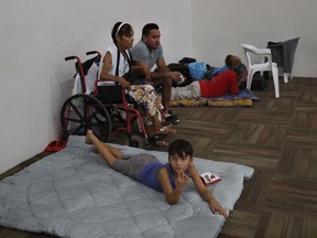 Residents gather in a temporary shelter before the arrival of Hurricane Willa, in Mazatlan, Mexico, Tuesday, Oct. 23, 2018. Willa is headed toward a Tuesday afternoon collision with a stretch of Mexico's Pacific coast, its strong winds and high waves threatening high-rise resorts, surfing beaches and fishing villages.