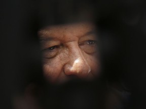 In this photo framed by the leg of a television tripod, Mexico's President Andres Manuel Lopez Obrador talks to the press during  a rally to honor the victims of the 1968 Tlatelolco massacre, outside of the Santiago Tlatelolco Church in Mexico City, Tuesday Oct. 2, 2018. Mexico commemorated the 50th anniversary of the massacre of students holding an anti-government protest, killed by men with guns and soldiers ten days before the 1968 Summer Olympics celebrations in Mexico City.