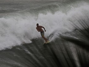 A surfer rides a wave before the arrival of Hurricane Willa, in Mazatlan, Mexico, Tuesday, Oct. 23, 2018. Emergency officials said they evacuated more than 4,250 people in coastal towns and set up 58 shelters ahead of the dangerous Category 3 storm.