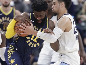 Memphis Grizzlies guard Dillon Brooks (24) ties up Indiana Pacers guard Tyreke Evans (12) during the first half of an NBA basketball game in Indianapolis, Wednesday, Oct. 17, 2018.