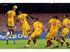 Roma's Aleksandar Kolarov, left, clears the ball during the Serie A soccer match between Napoli and Roma, at the San Paolo stadium in Naples, Italy, Sunday, Oct. 28, 2018.