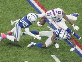 Buffalo Bills running back LeSean McCoy (25) is tackled by Indianapolis Colts cornerback Kenny Moore (23) and linebacker Anthony Walker (50) during the first half of an NFL football game in Indianapolis, Sunday, Oct. 21, 2018.