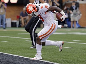 Clemson's Travis Etienne (9) runs for a touchdown against Wake Forest during the first half of an NCAA college football game in Charlotte, N.C., Saturday, Oct. 6, 2018.