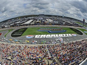 In this photo shot with a fisheye lens the field take the green flag to start the NASCAR Cup series auto race at Charlotte Motor Speedway in Concord, N.C., Sunday, Sept. 30, 2018.