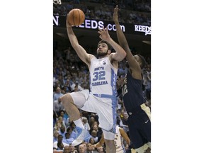 FILE - In this Feb. 3, 2018, file photo, North Carolina's Luke Maye (32) drives to the basket against Pittsburgh's Peace Ilegomah (42) during the second half of an NCAA college basketball game, in Chapel Hill, N.C. Maye was selected to The Associated Press preseason All-America team, Tuesday, Oct. 23, 2018.