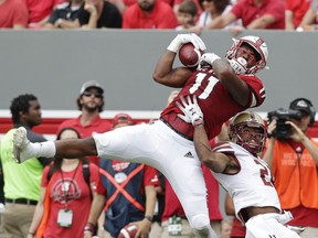 North Carolina State's Jakobi Meyers (11) catches a pass while Boston College's Taj-Amir Torres (24) defends during the first half an NCAA college football game in Raleigh, N.C., Saturday, Oct. 6, 2018.