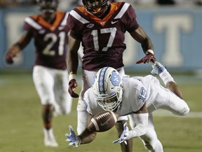 North Carolina's Dazz Newsome (19) reaches for a pass while Virginia Tech's Josh Jackson (17) defends during the first half of an NCAA college football game in Chapel Hill, N.C., Saturday, Oct. 13, 2018.