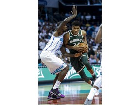 Milwaukee Bucks forward Giannis Antetokounmpo, right, of Greece, drives into Charlotte Hornets forward Marvin Williams in the first half of an NBA basketball game in Charlotte, N.C., Wednesday, Oct. 17, 2018.