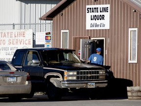 FILE - In this Oct. 21, 2016, file photo, a customer enters State Line Liquor, one of four beer stores in the town of Whiteclay, Neb.Activists are calling for more reforms in Whiteclay, even after a state Supreme Court decision closed the community's beer stores that sold millions of cans of beer each year despite an alcohol ban on a nearby Native American reservation.