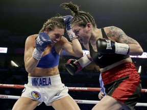 Mikaela Mayer, left, and Vanessa Bradford exchange blows during their super featherweight NABF title boxing bout in Omaha, Neb., Saturday, Oct. 13, 2018. Mikaela Mayer won by unanimous decision.