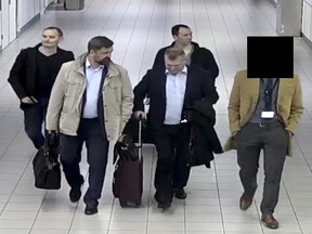 In this image released and manipulated at source by the Dutch Defense Ministry, Thursday Oct. 4, 2018, four Russian officers of the Main Directorate of the General Staff of the Armed Forces of the Russian Federation, GRU, are escorted to their flight after being expelled from the Netherlands on April 13, 2018, for allegedly trying to hack into the U.N. chemical watchdog OPCW's network.