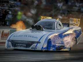 In this photo provided by the NHRA, Tommy Johnson Jr. drives to the provisional qualifying lead in Funny Car on Friday night, Oct. 5, 2018,at the AAA Texas NHRA FallNationals at Texas Motorplex in Ennis, Texas. Johnson's top run was 3.958 seconds at 323.66 mph.