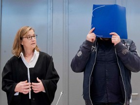 Former nurse Niels Hoegel, accused of killing more than 100 patients in his care, arrives with his lawyer Ulrike Baumann, in the courtroom, on October 2018 in Oldenburg, northern Germany, for the start of his trial. - Hoegel, 41, has already spent nearly a decade in prison for other patient deaths, and is accused of intentionally administering medical overdoses to victims so he could bring them back to life at the last moment.