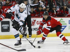 San Jose Sharks right wing Timo Meier (28) shoots the puck in front of New Jersey Devils left wing Taylor Hall (9) during the first period of an NHL hockey game, Sunday, Oct. 14, 2018, in Newark,N.J.