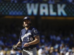 Milwaukee Brewers starting pitcher Wade Miley reacts after giving up a walk during the first inning of Game 5 of the National League Championship Series baseball game against the Los Angeles Dodgers Wednesday, Oct. 17, 2018, in Los Angeles.