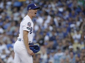 Los Angeles Dodgers' Walker Buehler reacts after getting Milwaukee Brewers' Ryan Braun to strike out during the third inning of Game 3 of the National League Championship Series baseball game Monday, Oct. 15, 2018, in Los Angeles.