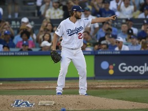 Los Angeles Dodgers's Clayton Kershaw gestures after an out during the seventh inning of Game 5 of the National League Championship Series baseball game against the Milwaukee Brewers Wednesday, Oct. 17, 2018, in Los Angeles.