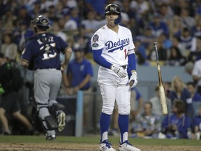 Los Angeles Dodgers' Enrique Hernandez reacts after striking out during the seventh inning of Game 3 of the National League Championship Series baseball game against the Milwaukee Brewers Monday, Oct. 15, 2018, in Los Angeles.