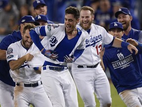 Los Angeles Dodgers' Cody Bellinger reacts after hitting a walk-off hit during the 13th inning of Game 4 of the National League Championship Series baseball game against the Milwaukee Brewers Tuesday, Oct. 16, 2018, in Los Angeles. The Dodgers won 2-1 to tie the series at 2-2.