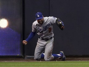Los Angeles Dodgers center fielder Chris Taylor (3) reacts after catching the fly ball hit by Milwaukee Brewers' Christian Yelich during the fifth inning of Game 7 of the National League Championship Series baseball game Saturday, Oct. 20, 2018, in Milwaukee.