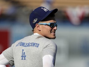Los Angeles Dodgers' Enrique Hernandez warms up before Game 2 of the baseball team's National League Division Series against the Atlanta Braves on Friday, Oct. 5, 2018, in Los Angeles.