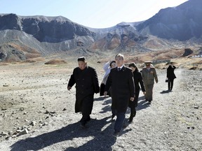 North Korean leader Kim Jong Un, left, and South Korean President Moon Jae-in visit Mount Paektu, in North Korea, Thursday, Sept. 20, 2018.