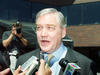 Conrad Black talks to reporters about the sale of his 50% stake in the National Post in front of the Post's former Toronto headquarters in 2001.