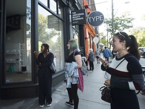 People react as they look outside the beauty supply store Deciem as it has closed all locations unexpectedly in Toronto on Tuesday, October 9, 2018.