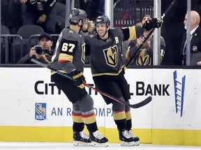 Vegas Golden Knights left wing Max Pacioretty (67) and center Jonathan Marchessault (81) react after Marchessault's goal during the first period of an NHL hockey game against the Buffalo Sabres, Tuesday, Oct. 16, 2018, in Las Vegas.
