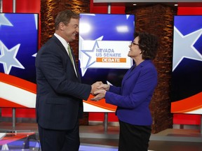 Sen. Dean Heller, R-Nev., left, and Rep. Jacky Rosen, D-Nev., shake hands before a U.S. Senate debate, Friday, Oct. 19, 2018, in Las Vegas.