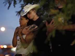 People attend a ceremony to dedicate a memorial garden for victims, Monday, Oct. 1, 2018, on the anniversary of the mass shooting a year earlier, in Las Vegas.